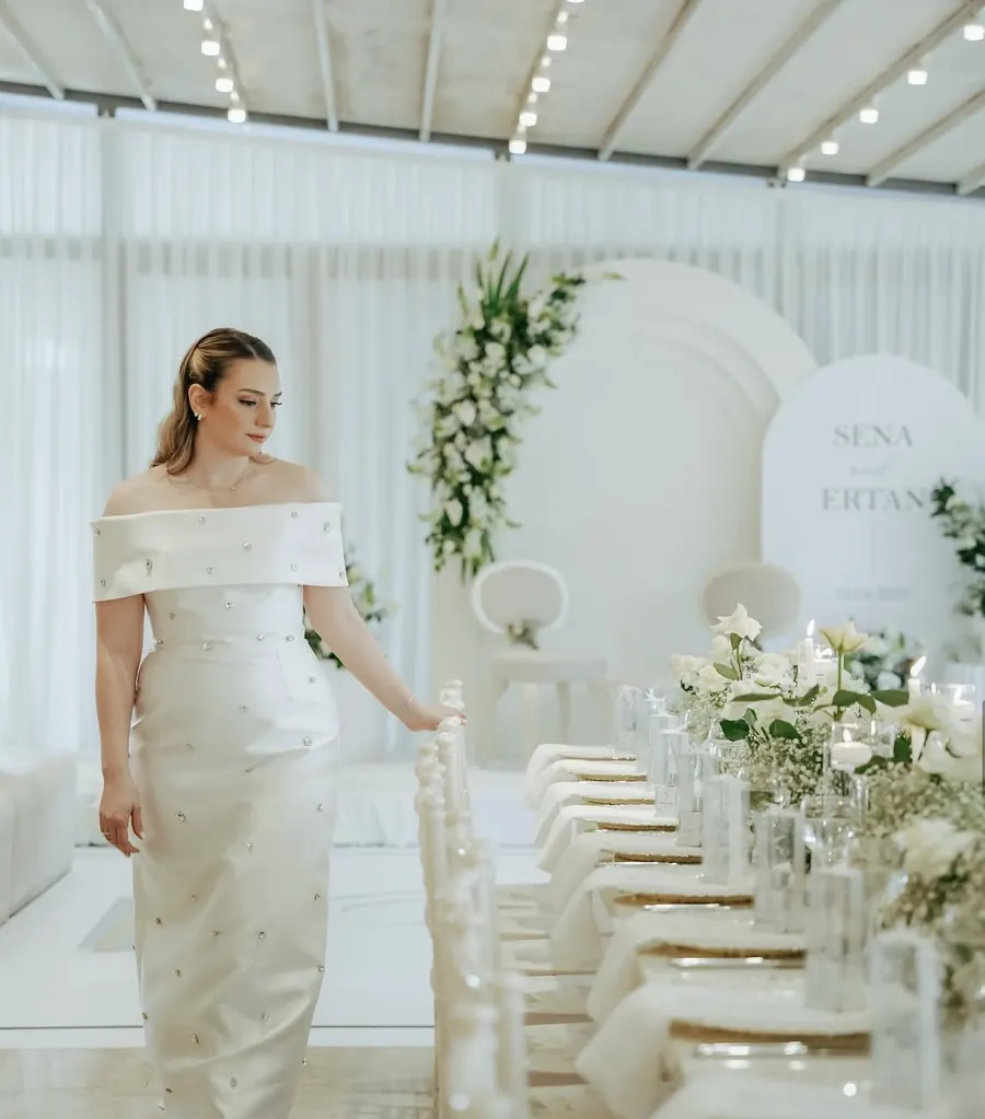 Bride beside a table with white flowers