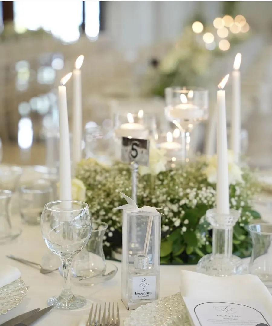 Table with candles and white flowers